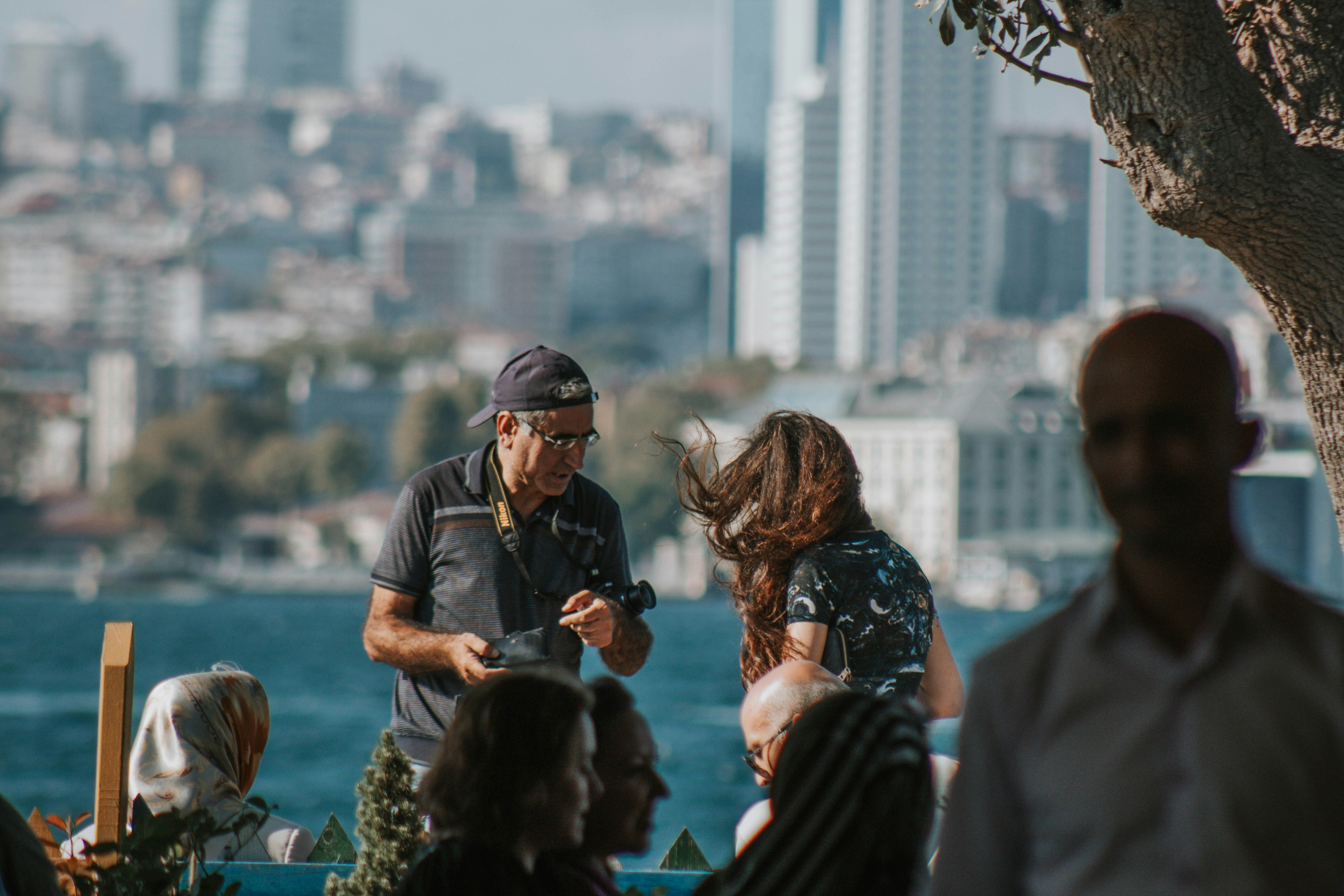 man in black t-shirt and black cap standing near woman in black jacket during daytime